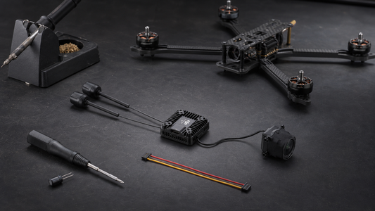 DJI O4 Pro Air Unit beside a modular five-inch FPV quad on a workshop bench