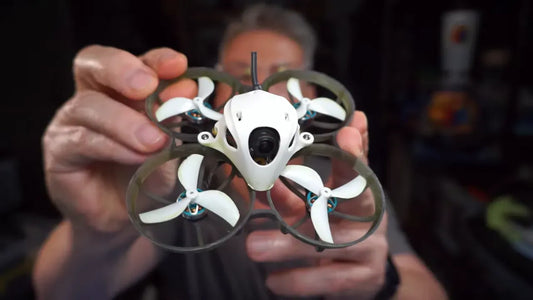 Close view of the white Meteor75 Pro HD quad from the front showing the camera canopy and ducts