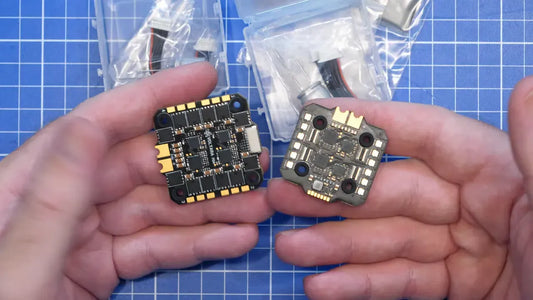 Two Voltara ESC boards held side by side above a blue cutting mat