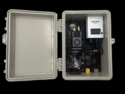 Open electronic box with VRX BOX device on a white background