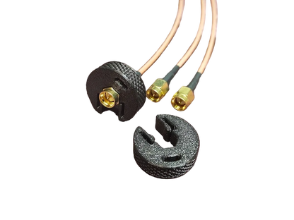 Two black connectors with gold SMA ends
