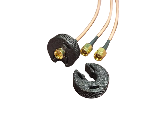 Two black connectors with gold SMA ends