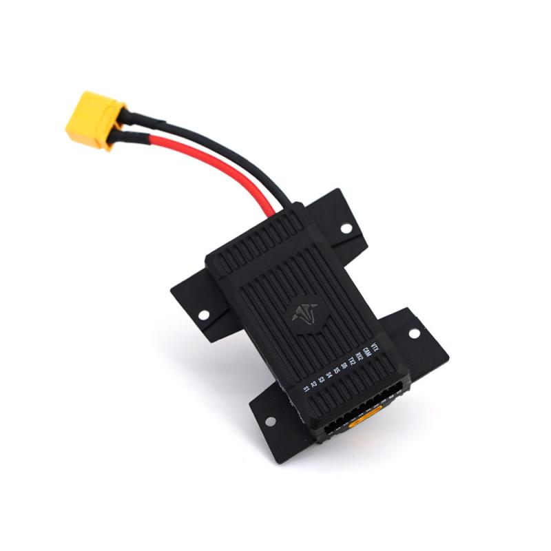 Black electronic module with red and black wires on a white background