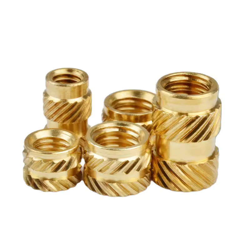 Set of gold metal thread inserts on a white background
