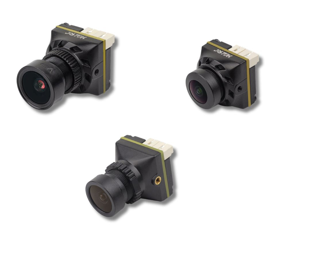 Three small FPV drone cameras on a white background