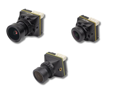 Three small FPV drone cameras on a white background