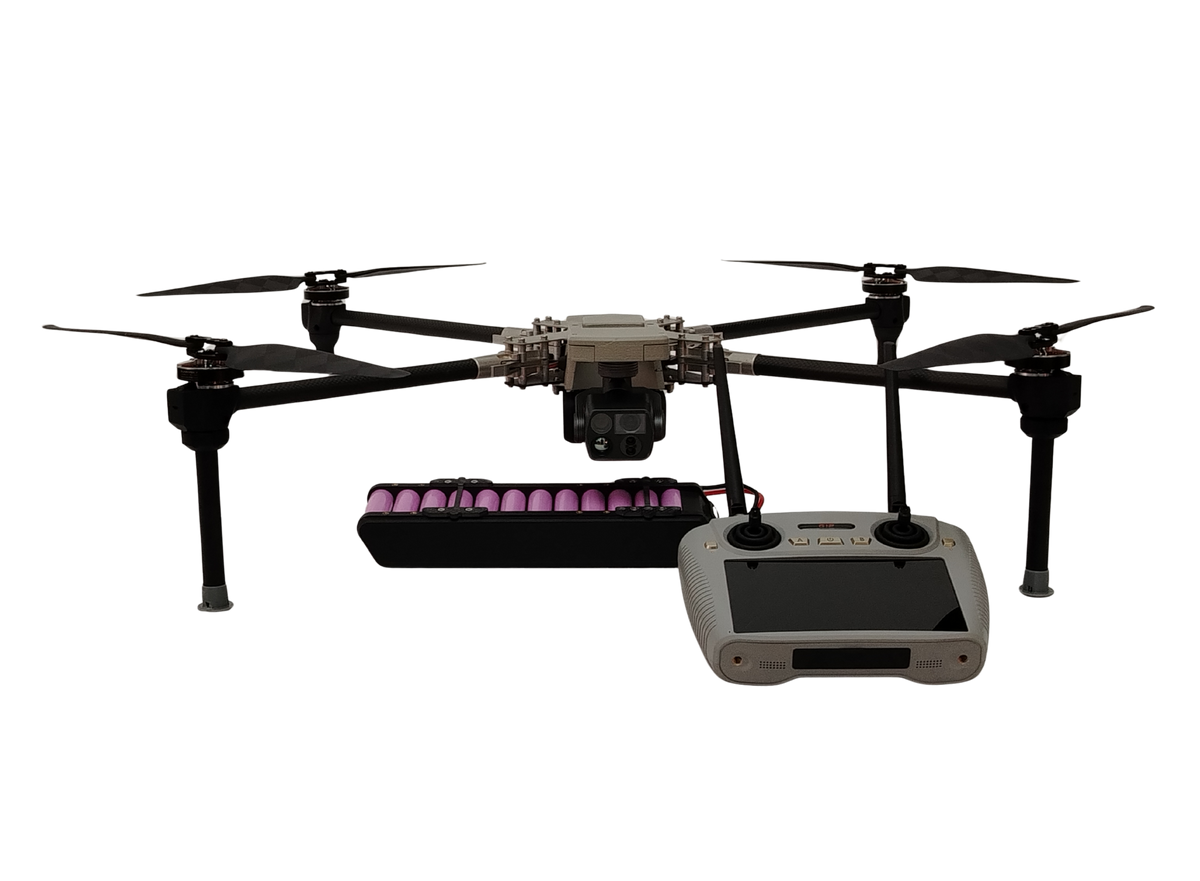 A quadcopter drone with a mounted camera, shown with a battery pack and a handheld remote controller on a plain white background.