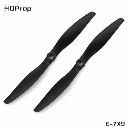 A black quadcopter replacement propeller, model E-7X9, shown diagonally on a plain white background with the HQProp brand logo in the top-left corner and the model number in the bottom-right.