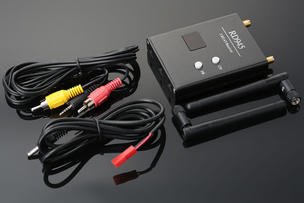 Black electronic device with antennas and cables on a dark background